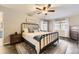 Main bedroom featuring a wrought iron bed frame, decorative rug, and windows with coverings for natural light at 4305 Red Rock Dr, Larkspur, CO 80118
