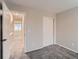 Small bedroom featuring new carpet, neutral gray walls, and a sliding door closet at 500 Lashley St # 58, Longmont, CO 80504