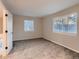 Spacious bedroom featuring new carpet, neutral gray walls, two windows, and white trim at 500 Lashley St # 58, Longmont, CO 80504