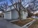 Two-story home with gray siding and attached garage, showcasing curb appeal and functionality at 500 Lashley St # 58, Longmont, CO 80504