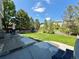 Lush backyard with a well-manicured lawn, mature trees, patio and other yard furniture at 16063 E 106Th Ct, Commerce City, CO 80022
