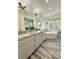 Beautiful bathroom featuring double vanities, modern fixtures, wood floors, and a soaking tub by the window at 16063 E 106Th Ct, Commerce City, CO 80022
