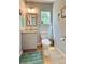 Bathroom has a gray vanity with granite countertop and a toilet at 16063 E 106Th Ct, Commerce City, CO 80022