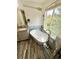 Bright bathroom with modern finishes, a soaking tub, wood floors and a window offering natural light at 16063 E 106Th Ct, Commerce City, CO 80022