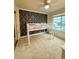 bedroom featuring an elevated bed, patterned accent wall, and a ceiling fan at 16063 E 106Th Ct, Commerce City, CO 80022