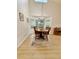 Well-lit dining room with a round wooden table, bay window, and piano at 16063 E 106Th Ct, Commerce City, CO 80022