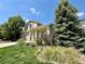 Inviting two-story home with lush landscaping and a welcoming front porch at 16063 E 106Th Ct, Commerce City, CO 80022