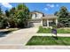 Charming two-story home with a well-manicured front yard and attached two car garage at 16063 E 106Th Ct, Commerce City, CO 80022