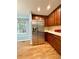 This kitchen features stainless refrigerator and wooden cabinets at 16063 E 106Th Ct, Commerce City, CO 80022