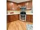 This kitchen has wooden cabinets, stainless appliances, and quartz countertops at 16063 E 106Th Ct, Commerce City, CO 80022
