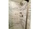 Detailed view of the tiled shower, showcasing its rainfall shower head and built-in shelving at 16063 E 106Th Ct, Commerce City, CO 80022