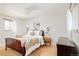 Serene main bedroom features hardwood floors, a cozy bed, and lots of natural light at 966 S Johnson St, Lakewood, CO 80226