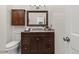 Bathroom featuring a wooden vanity, granite countertops, and an overhead light fixture at 2363 Ranch Dr, Westminster, CO 80234