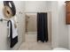 Bathroom featuring a tiled shower and neutral decor at 2363 Ranch Dr, Westminster, CO 80234