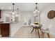 Eat-in kitchen with white table, pendant lighting, white trim, and access to back patio at 2363 Ranch Dr, Westminster, CO 80234