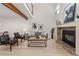 Bright living room featuring high ceilings, wood floors, with modern fireplace at 2363 Ranch Dr, Westminster, CO 80234