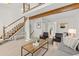 Living room featuring high ceilings, wood beam, wood floors, with modern furniture at 2363 Ranch Dr, Westminster, CO 80234