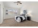 Comfortable bedroom featuring a modern art piece, ceiling fan, and lamps at 2363 Ranch Dr, Westminster, CO 80234