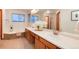 Well-lit bathroom featuring a double sink vanity, and a separate soaking tub at 10233 Silver Maple Cir, Highlands Ranch, CO 80129