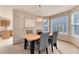 Elegant dining room showcasing a wood table, upholstered chairs, and a modern light fixture at 10233 Silver Maple Cir, Highlands Ranch, CO 80129