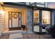 Inviting front porch with decorative wreath, colorful flowers, and stone accents at 10233 Silver Maple Cir, Highlands Ranch, CO 80129