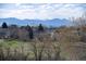 The neighborhood is surrounded by mature trees and beautiful mountain views at 10233 Silver Maple Cir, Highlands Ranch, CO 80129