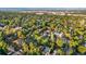 Panoramic aerial shot over a green neighborhood with scattered houses and distant mountain views at 1815 S Ogden St, Denver, CO 80210