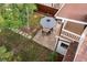 Aerial shot of backyard featuring a stone patio, a black and white striped umbrella, and manicured lawn at 1815 S Ogden St, Denver, CO 80210