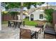 Charming backyard featuring stone patio, outdoor dining set, and manicured landscaping at 1815 S Ogden St, Denver, CO 80210