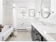 Elegant bathroom featuring classic tub, marble counters, hexagon tile floors, and modern fixtures at 1815 S Ogden St, Denver, CO 80210