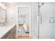 Bathroom featuring shower, patterned wallpaper and access to the main bedroom at 1815 S Ogden St, Denver, CO 80210