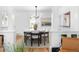 Bright dining room featuring a modern chandelier, sleek table and chairs, and decorative rug at 1815 S Ogden St, Denver, CO 80210