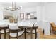 Bright dining room area with access to the kitchen featuring hardwood floors and elegant decor at 1815 S Ogden St, Denver, CO 80210