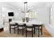 Dining room with white walls, hardwood floors, a fireplace and a flat screen television at 1815 S Ogden St, Denver, CO 80210