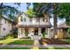 Traditional two-story home with a manicured lawn, mature trees and inviting entrance at 1815 S Ogden St, Denver, CO 80210