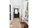 Bright hallway featuring hardwood floors, a decorative runner, and stylish decor at 1815 S Ogden St, Denver, CO 80210