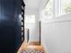 Hallway featuring wood floors, a storage cabinet, and a large window at 1815 S Ogden St, Denver, CO 80210