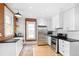 Bright kitchen with stainless steel appliances, exposed brick, and white cabinetry at 1815 S Ogden St, Denver, CO 80210