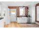 Charming kitchen featuring white cabinets, a farmhouse sink, and exposed brick at 1815 S Ogden St, Denver, CO 80210