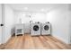 Efficient laundry room with modern washer and dryer units, and sleek sink setup at 1815 S Ogden St, Denver, CO 80210