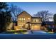 Stunning two-story home with a brick facade, large windows, and a modern garage door at 355 Forest St, Denver, CO 80220