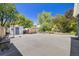 A spacious backyard with a basketball hoop, a shed, wooden bench and privacy fence at 2773 S Macon St, Aurora, CO 80014