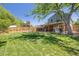 Large backyard with mature trees and a privacy fence at 2773 S Macon St, Aurora, CO 80014