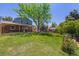 Huge backyard with covered patio, mature trees, and beautiful lawn at 2773 S Macon St, Aurora, CO 80014