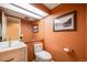 Cozy powder room featuring a white vanity, updated fixtures, and artistic accents at 2773 S Macon St, Aurora, CO 80014
