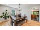 Elegant dining room featuring a large table, bench seating, and stylish light fixture at 2773 S Macon St, Aurora, CO 80014