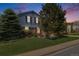 Charming two-story home with brick accents and lush landscaping at twilight at 2773 S Macon St, Aurora, CO 80014