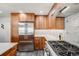 A bright kitchen features stainless steel appliances, custom backsplash and updated cabinets at 2773 S Macon St, Aurora, CO 80014