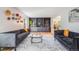 Spacious living room with built-in bookshelves and two gray loveseats at 2773 S Macon St, Aurora, CO 80014