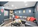 Finished basement featuring a wet bar, modern sofa, and custom wall art at 10286 Rotherwood Cir, Highlands Ranch, CO 80130